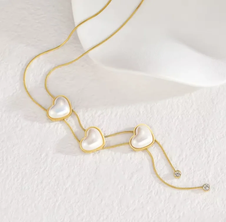 قلاده باللون الذهبي مزين بثلاث قلوب من اللؤلؤ الأبيض